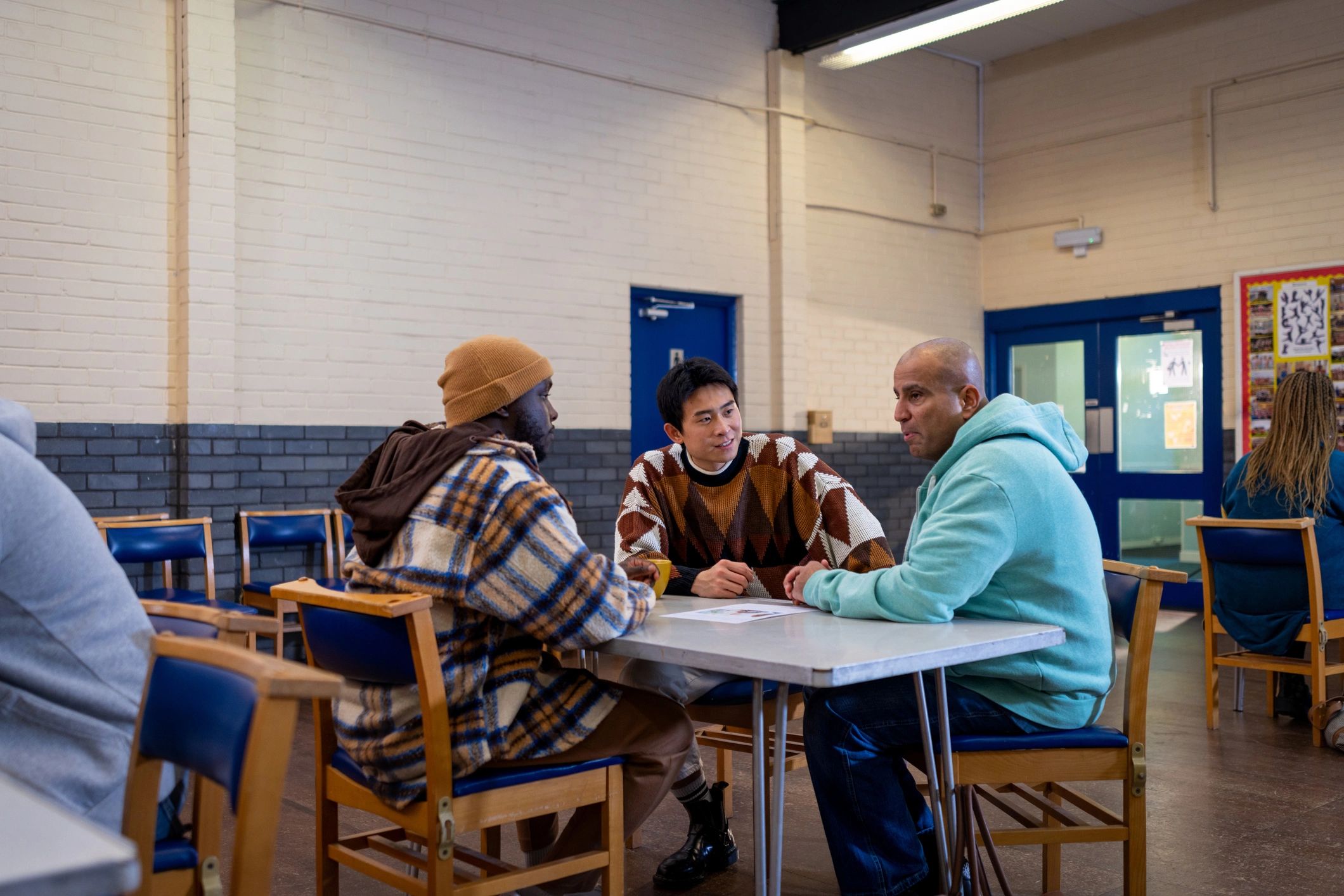 Adults speaking together at a community center
