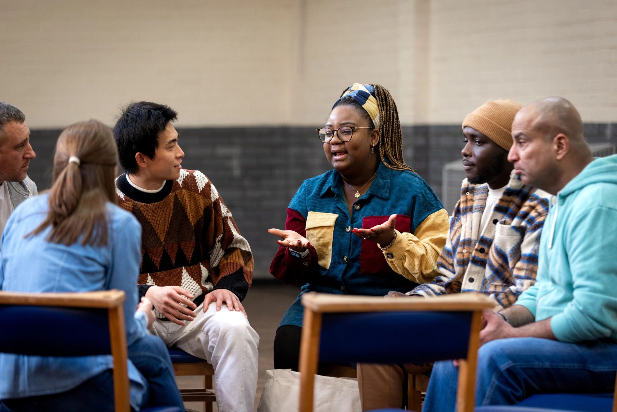 Adults seated in a circle during a community discussion