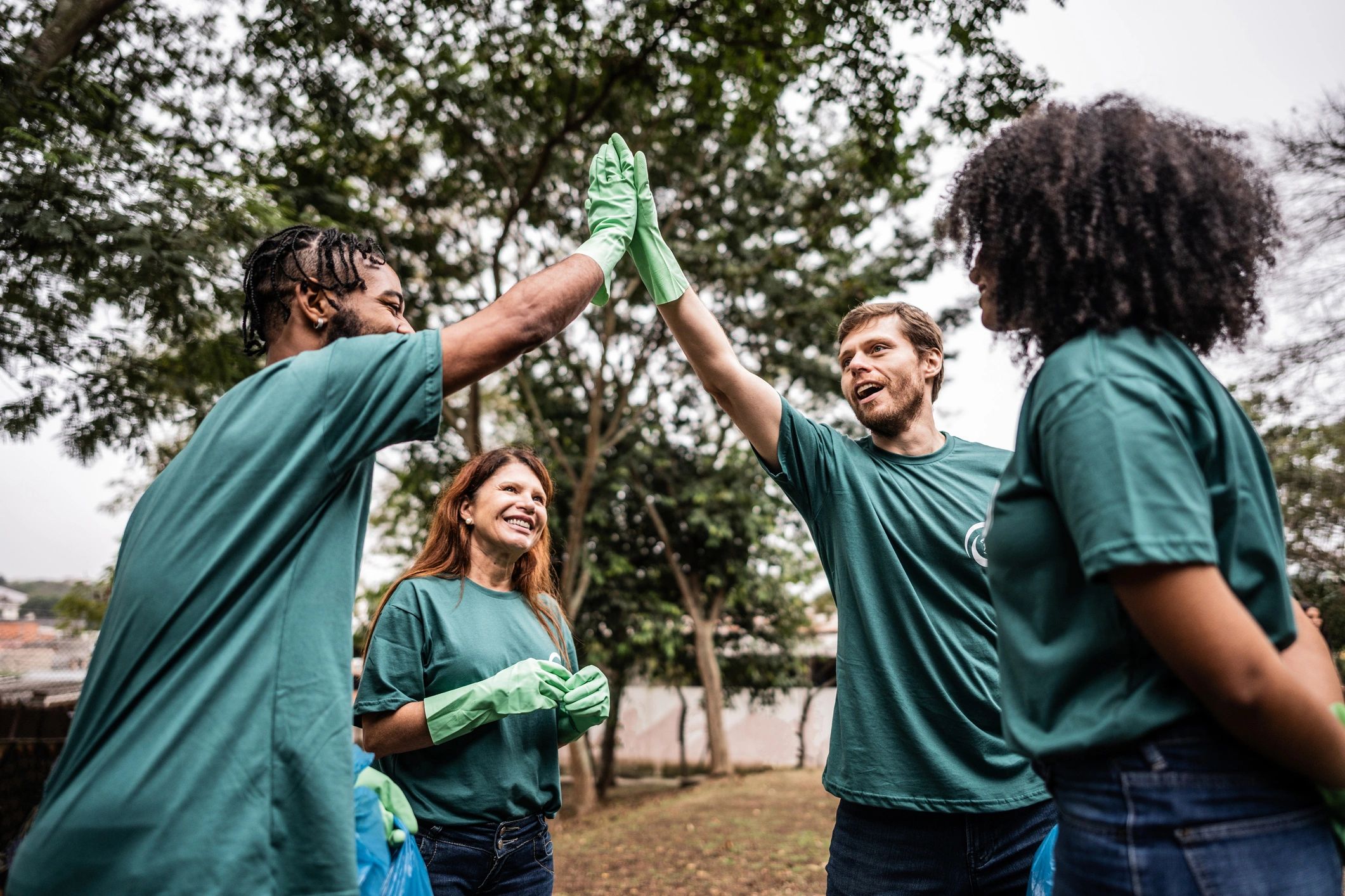 Young volunteers greeting each other at a public park