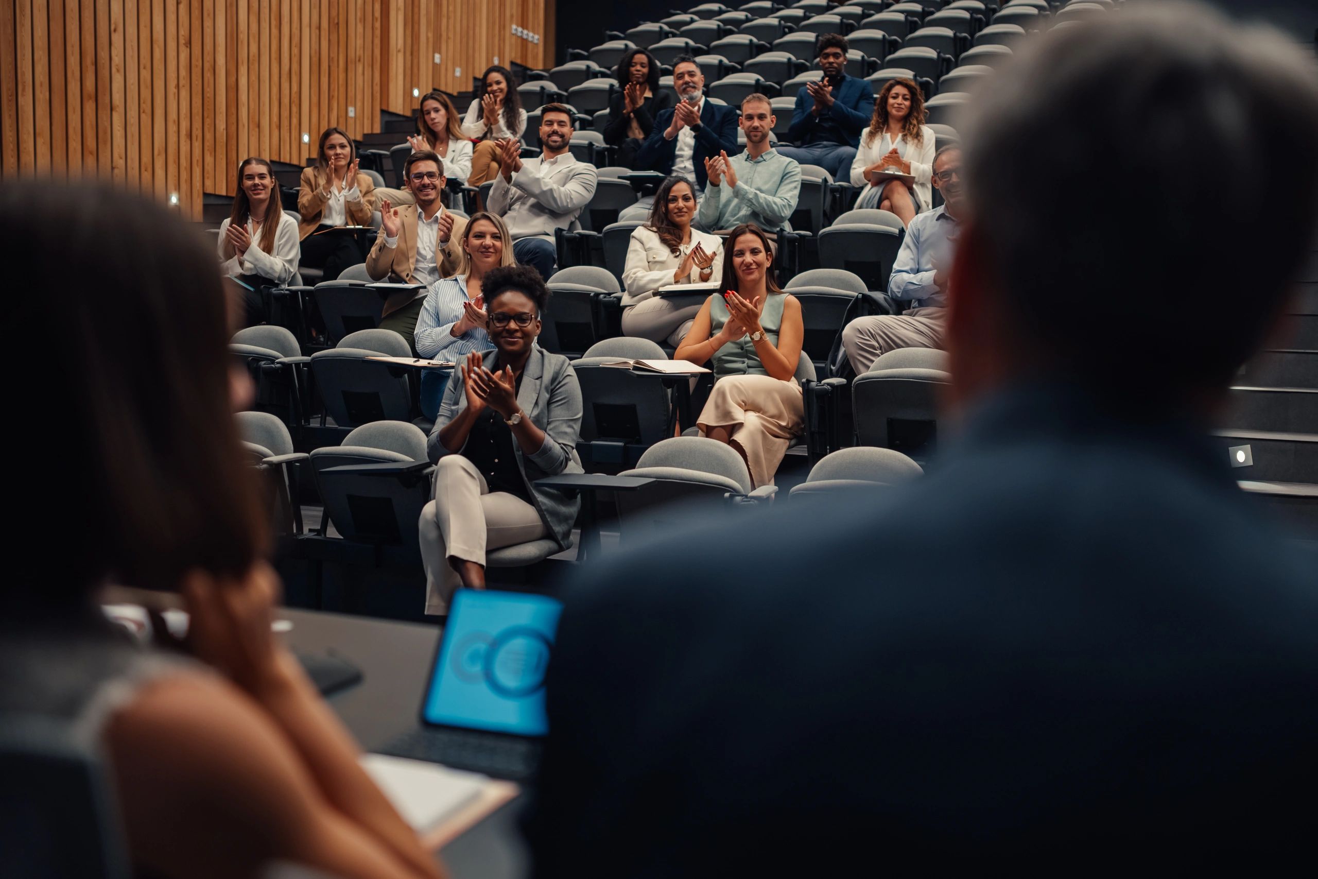 Audience applauding at a community presentation